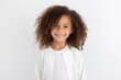 © Anne-Marie Albrecht - Medium shot portrait of a Brazilian child female in a white background wearing a chic cardigan