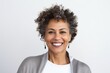 © Anne-Marie Albrecht - Portrait of smiling businesswoman with afro hairstyle against white background