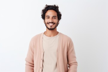 Wall Mural - Portrait of a handsome young man smiling at camera over white background