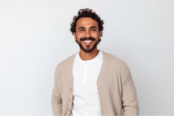 Portrait of young handsome man with curly hair looking at camera and smiling.