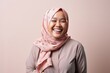 © Anne-Marie Albrecht - Portrait of happy Asian muslim woman wearing hijab smiling at camera.