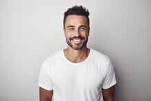 Lifestyle Portrait Of A Brazilian Man In His 30s In A Minimalist Or Empty Room Background Wearing A Simple Tunic