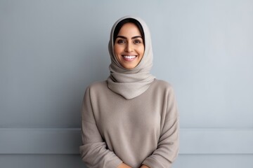 Wall Mural - Portrait of a smiling muslim woman in hijab looking at camera