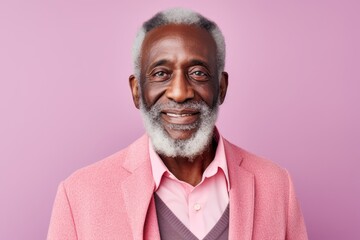 Wall Mural - Portrait of senior african american man with white beard and mustache wearing pink jacket and looking at camera.