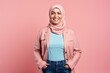 © Anne-Marie Albrecht - Portrait of a smiling muslim woman in hijab isolated on pink background