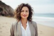 © Leon Waltz - Lifestyle portrait of a Brazilian woman in her 40s in a beach background wearing a classic blazer