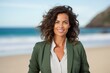 © Leon Waltz - Lifestyle portrait of a Brazilian woman in her 40s in a beach background wearing a classic blazer