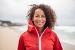 © Leon Waltz - Lifestyle portrait of a Brazilian woman in her 40s in a beach background wearing a lightweight windbreaker