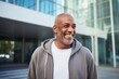 © Leon Waltz - Portrait of happy african american man smiling in urban background