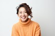 © Eber Braun - Portrait of a Chinese woman in her 30s in a white background wearing a cozy sweater