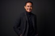 © Leon Waltz - Portrait of young handsome Asian businessman against black backgroun