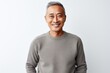 © Hanne Bauer - Portrait of smiling asian man in grey pullover against white background