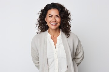 Wall Mural - Portrait of a happy businesswoman smiling at camera over white background