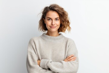 Portrait of smiling young woman with crossed arms looking at camera isolated on white background