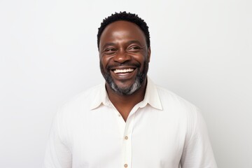 Wall Mural - Portrait of happy african american man smiling at camera over white background