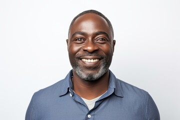 Wall Mural - Portrait of happy African-American man smiling at camera against white background