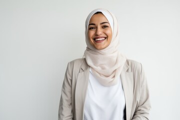 Wall Mural - Portrait of a Saudi Arabian woman in her 40s in a white background wearing a chic cardigan