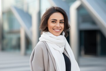 Wall Mural - Portrait of a Saudi Arabian woman in her 30s in a modern architectural background wearing a chic cardigan