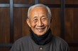 Portrait of a 100-year-old elderly chinese man in an abstract background wearing a chic cardigan