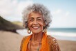 © Eber Braun - Portrait of smiling senior woman standing on the beach and looking at camera