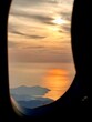 sunrise over the sea on the door of air plane