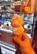 hand holding ice cream at ice cream shop