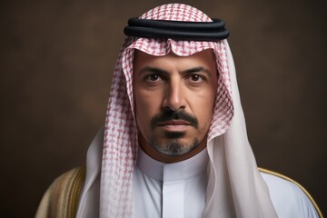 Wall Mural - Portrait of a Saudi Arabian man in his 40s in an abstract background wearing a foulard