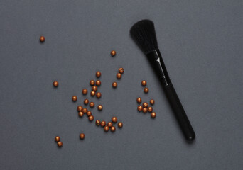 Wall Mural - Black make-up brushes with powder balls on a dark background