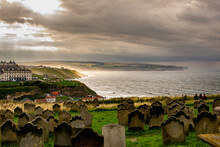 Sunset Over Graveyard In Whitby Seaside Town In North Yorkshire, England, UK On A Stormy And Rainy Day