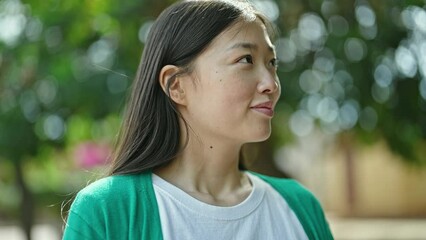 Sticker - Young chinese woman smiling confident breathing at park