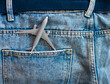 Travel concept passenger plane in jeans pocket. Top view airplane model gray spruce on denim blue trousers
