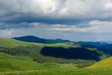 Canvas Print - Green hills with dramatic clouds forming in the sky above, Carpathian mountains