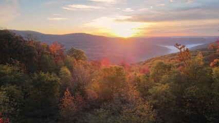 Wall Mural - Colorful mountain view sunrise over Ozark Mountains with foggy valley and autumn colored trees shot via drone aerial 