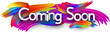 Coming soon paper word sign with colorful spectrum paint brush strokes over white. Vector illustration.