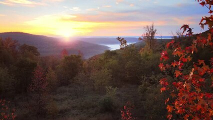 Wall Mural - Colorful mountain view sunrise over Ozark Mountains with foggy valley and autumn colored forest shot