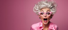 Surprised Mature Woman With Glasses With Big Hair On An Pink Background With Space For Copy