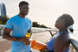 © Maria Vitkovska - Smiling beautiful african american couple talking after working out outdoors. Healthy lifestyle