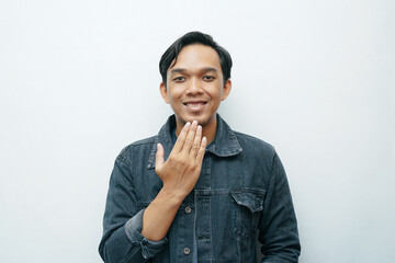 Portrait of Indonesian Asian man showing thank you sign language for deafness gesture. Isolated white background