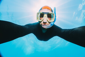 Wall Mural - men using a stinger suit in the great barrier reef in summer time .