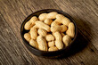 Peanuts with nutshell on a bowl, studio shot