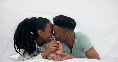 Poster - Black couple, bed and kiss with happy love under a bedroom blanket in the morning at home. Smile, funny and young people relax together with support and care in house with commitment and romance