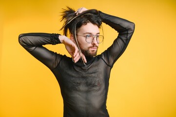 Gay man hold rainbow striped flag isolated on colored background studio portrait. People lifestyle fashion lgbtq concept