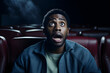 black man in cinema terrified reaction