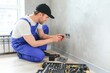 © Serhii - Construction worker electrician assembles an electrical outlet in an apartment