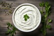 Top view of white bowl with herbed sour cream dip. Generative AI