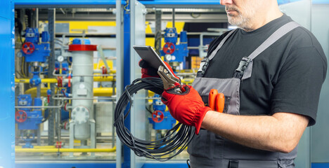 Poster - technician inside factory. cropped man electrician. factory worker with tablet. electrical installer