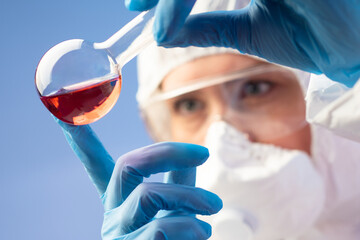 Poster - face biologist. laboratory assistant with flask. scientist is holding test tube with red liquid. bio