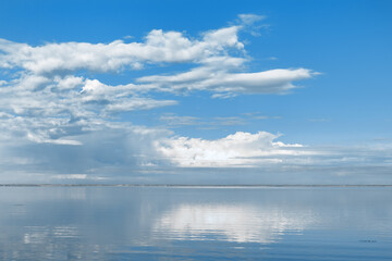  Nature picturesque landscape, clouds reflected on water surface, windless summer weather, tranquil blue trend sky background, mirroring sky on water, white blue nature gradient, aesthetic