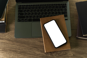 Poster - Top view of computer desk with smartphone with blank screen and modern frame less design for your advertising text message