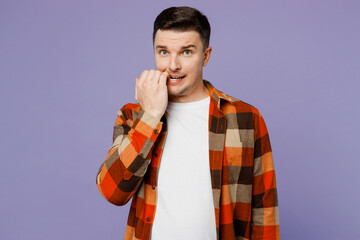 Wall Mural - Young sad confused minded man he wears checkered shirt white t-shirt casual clothes look camera biting nails fingers isolated on plain pastel light purple background studio portrait Lifestyle concept